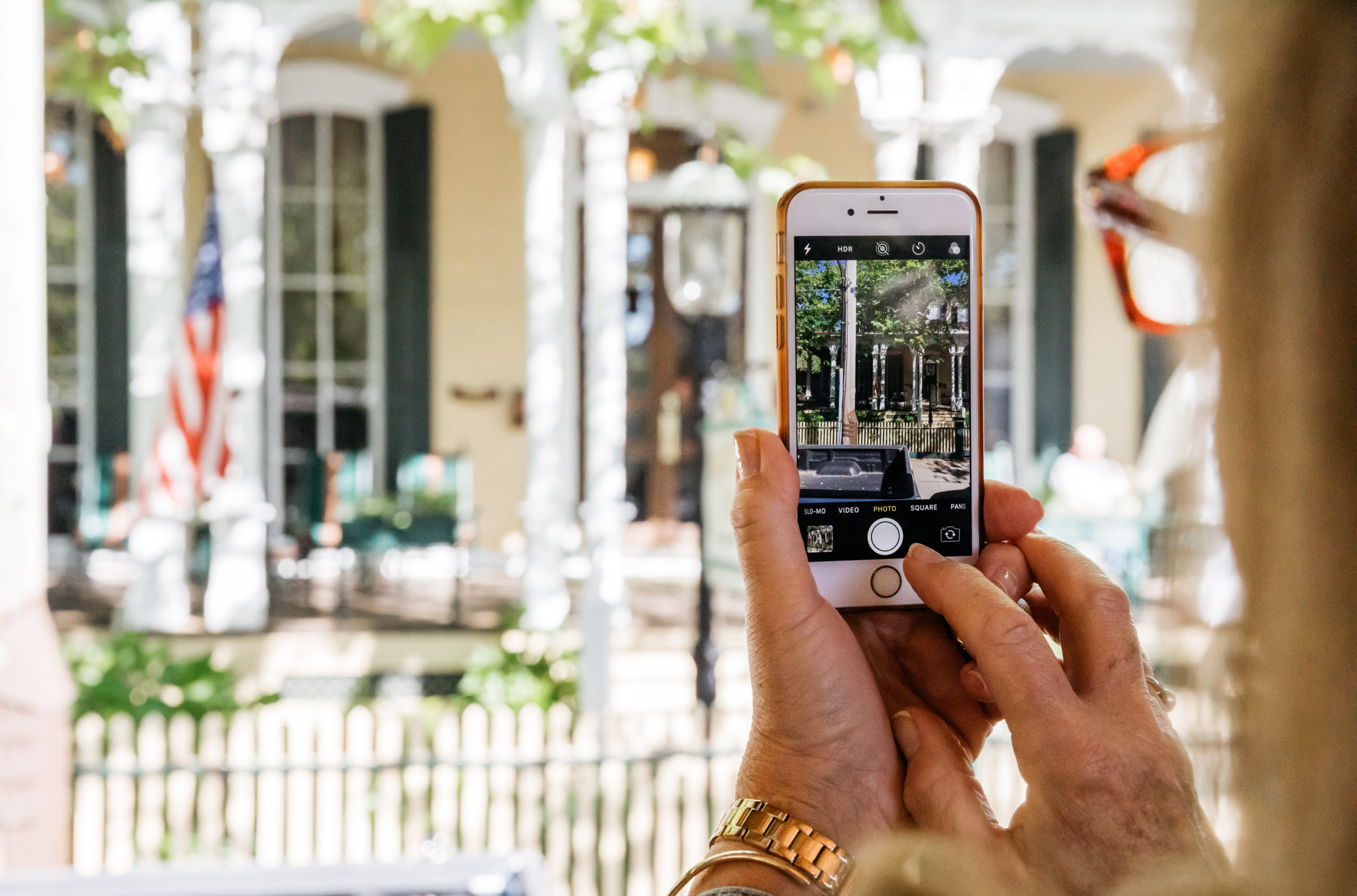 older woman taking photo of a cape may B&B