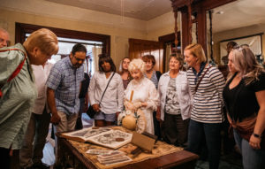 Tour guide showing victorian era items inside the emlen physick estate