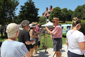 A Tom Carroll showing off his Penny Farthing bike at the cape may mac Hops Festival