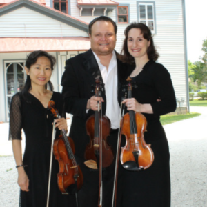 BACHS LUNCHES 600×600 3 violinist standing outside of the carriage house on the emlen physick estate getting read to play a bach's lunch