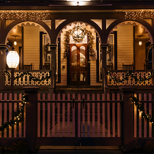 a victorian porch decorated for christmas