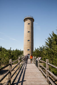 two people walking towards the entrance of the world war ii lookout tower in cape may new jersey