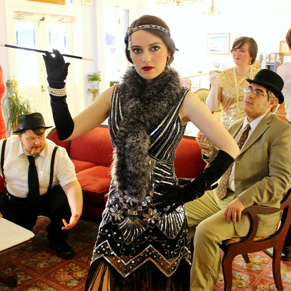 Actors dressed as flappers in 1920s clothing