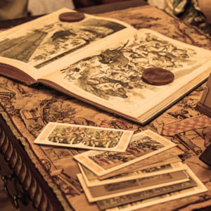 PHysick estate-ghost tour-sepia 600×600 tarrot cards and an open book about spirits sitting on a coffee table in the emlen physick estate house museum in cape may new jersey