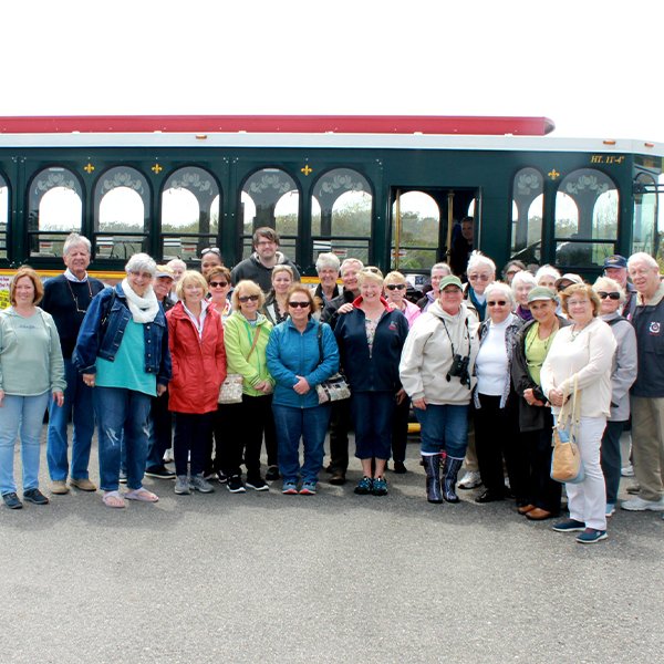 friends of the lh 600×600 A large group of people standing outside with the cape may mac trolley behind them