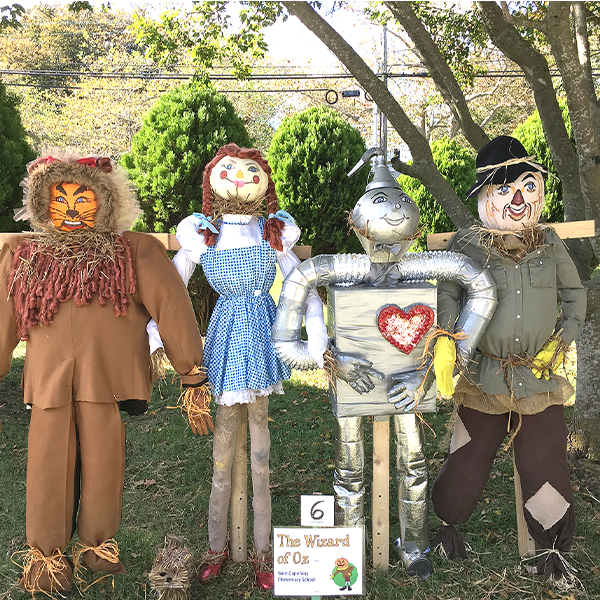 scarecrows dressed as wizard of oz characters