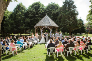 outdoor wedding ceremony in front of a gazebo