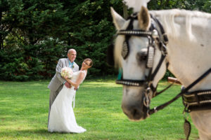 bride and groom with horse in the foreground