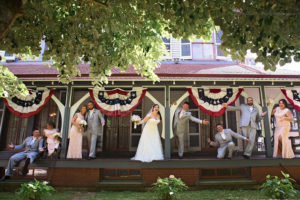 wedding party on the porch of a Victorian house