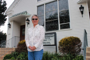 Woman standing in front of a church