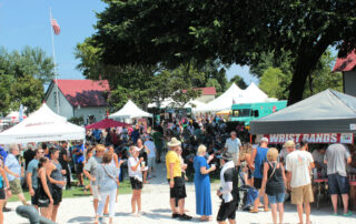 a crowd of people outdoors at a festival