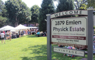 Physick Estate welcome sign with festival in the background