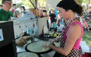 woman making crepes at a festival