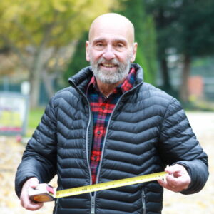 Man standing with a measuring tape