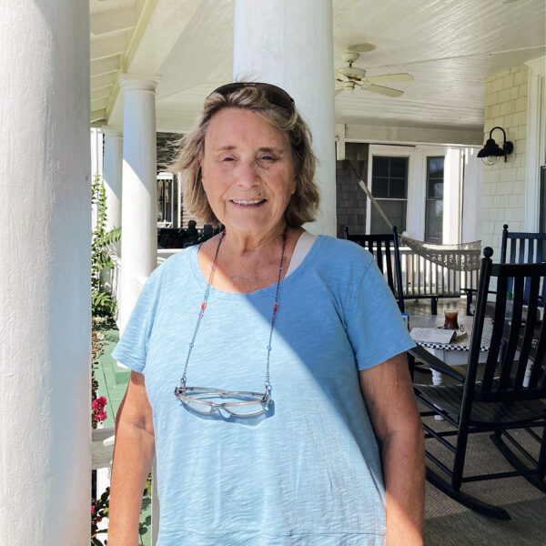 Carol Crossed VOM January 2023 photo of a woman in a blue shirt standing on a porch