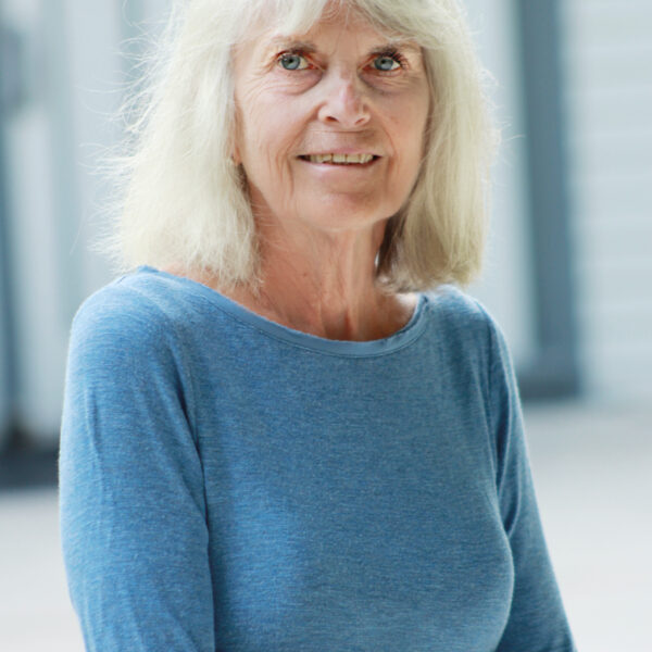 photo of a woman with grey hair and a blue shirt