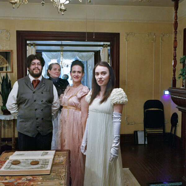 costumed actors in a victorian parlor