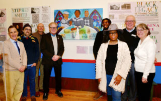 people at a gallery standing in front of a painting