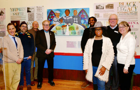 people at a gallery standing in front of a painting
