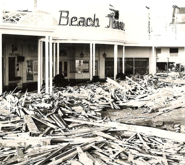 black and white photo of destruction from a hurricane in front of a theater